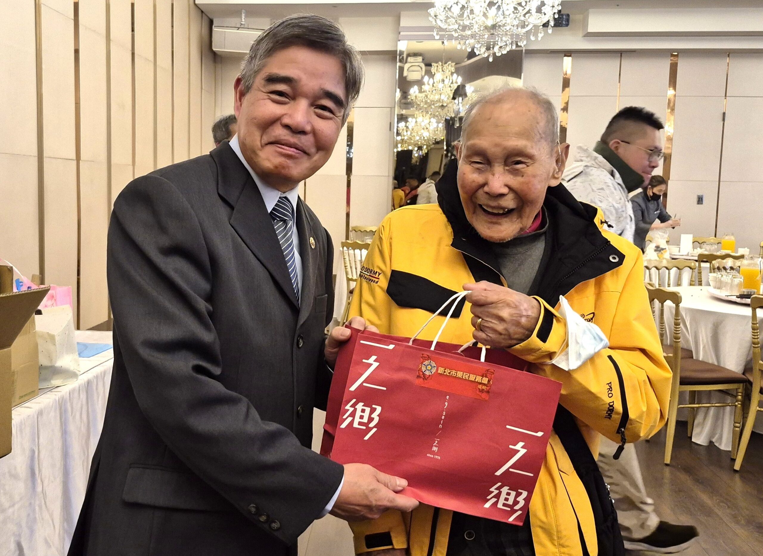 百歲人瑞高歌迎新 新北榮服處圍爐共享團圓飯香 8 《圖說》林振生處長(左)致贈伴手禮予106歲方爺爺。〈新北榮服處提供〉